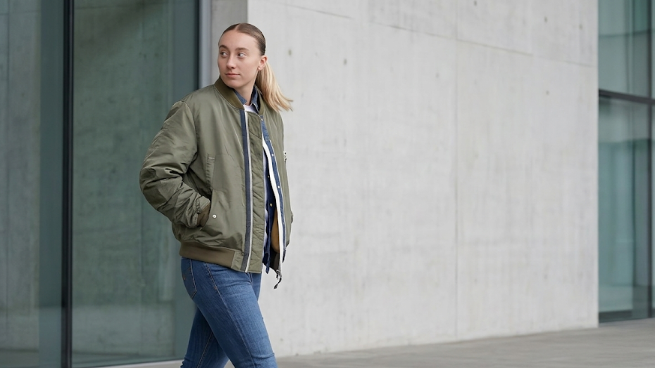 Paige Bueckers 2026 Dallas Wings NBAE olive green oversized bomber jacket with utility sleeve pocket and rib-knit trims streetwear tunnel look