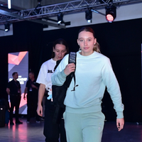 Paige Bueckers wearing a mint green Las Vegas Aces vs Dallas Wings embroidered crewneck sweatshirt featuring a relaxed fit, ribbed cuffs, and modern game-day streetwear styling.
