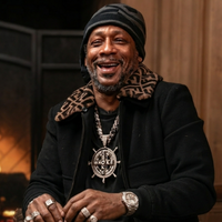 Katt Williams Fendi black bomber jacket with fur collar from viral Shannon Sharpe interview showcasing luxury streetwear style