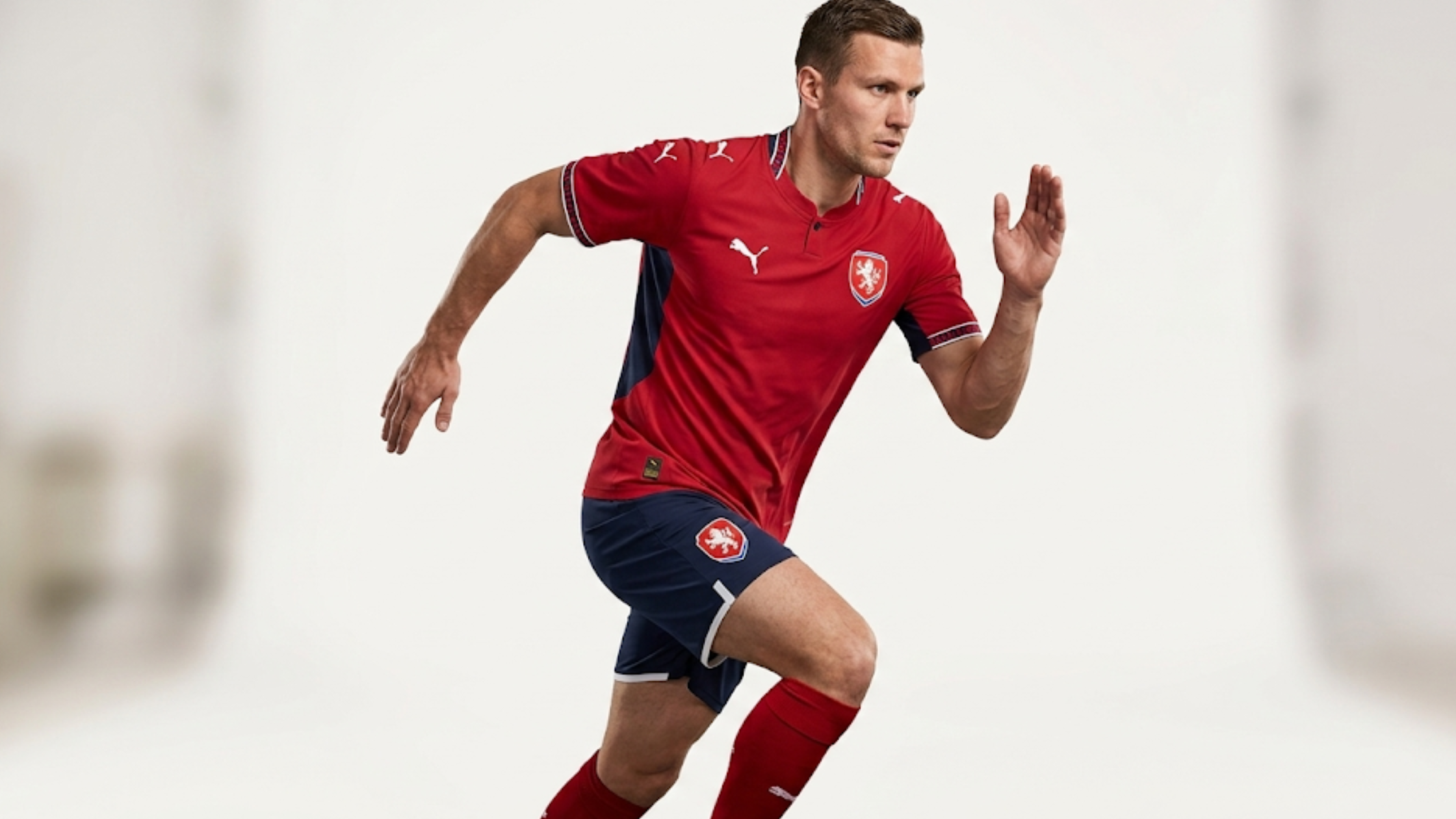 Czechia 2026 home football jersey red base navy side panels Henley collar Czech lion crest Puma logo sportswear