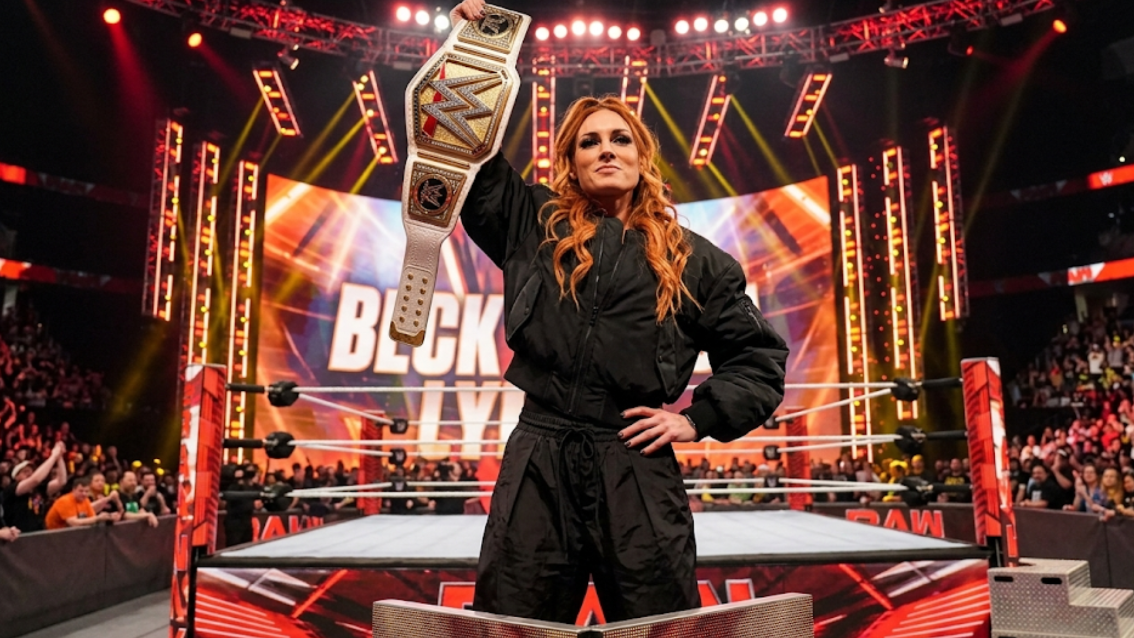 Becky Lynch Monday Night RAW 2026 oversized black MA-1 bomber jacket quilted padded cropped WWE streetwear look