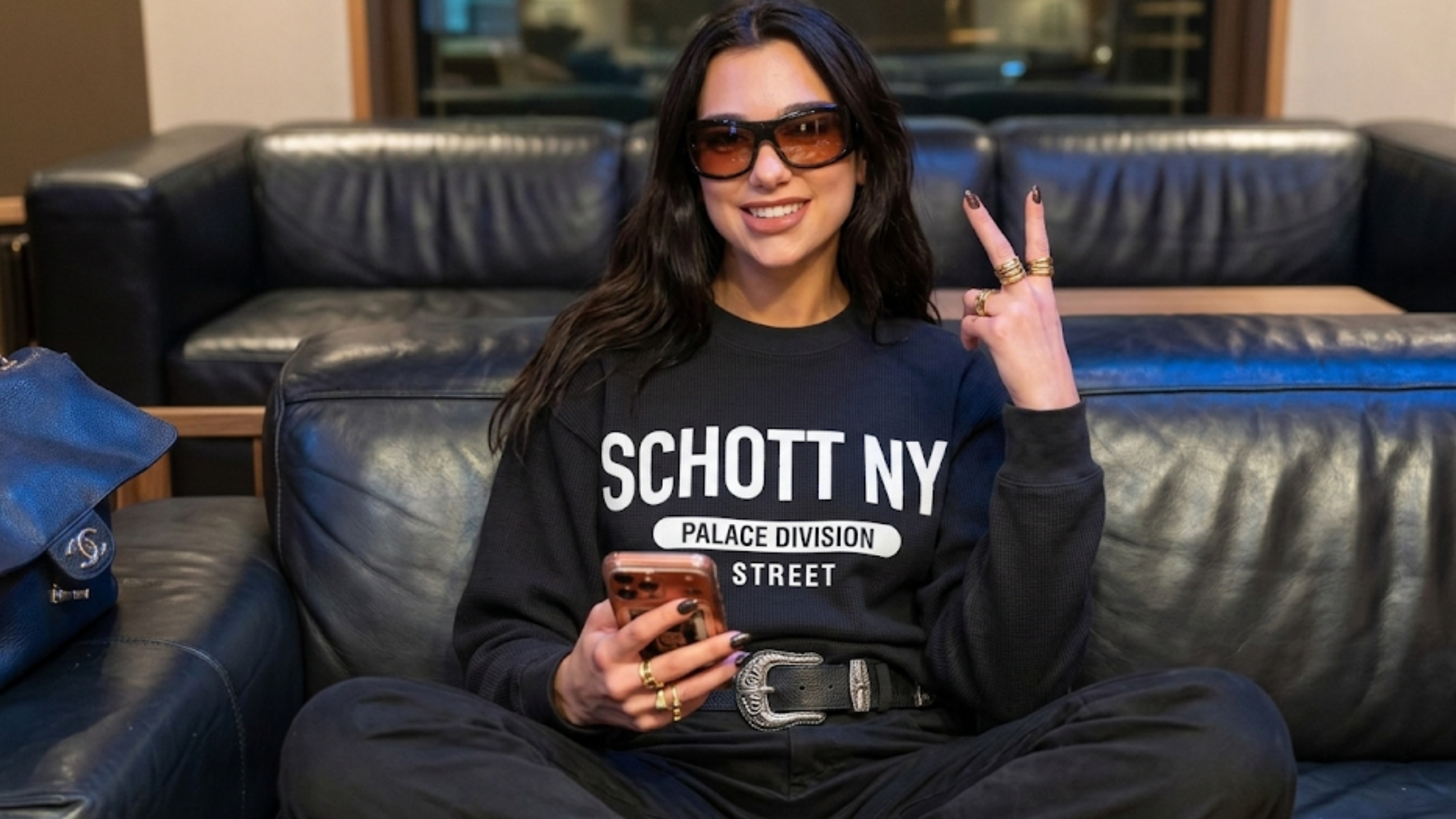 Dua Lipa Schott NYC Palace Division black crewneck sweatshirt NYC address graphic heavyweight fleece streetwear outfit