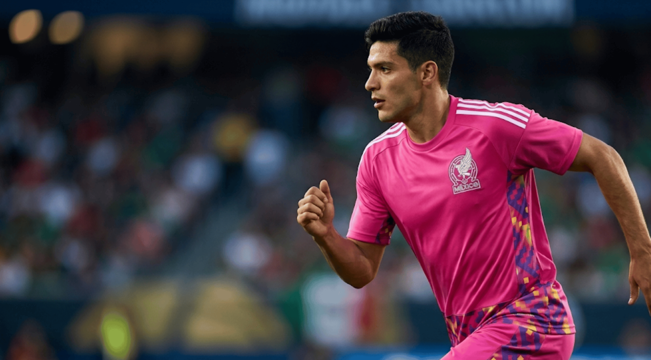 A close-up view of the FIFA World Cup Mexico 26 Home Goalkeeper Jersey in vibrant hot magenta pink with Aztec-inspired geometric side panels and the white Mexico crest.