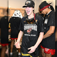 Caitlin Clark 2025 WNBA Commissioner’s Cup Champions black T-shirt featuring bold “CHAMPIONS” lettering, Indiana Fever logo, and gold trophy graphic design