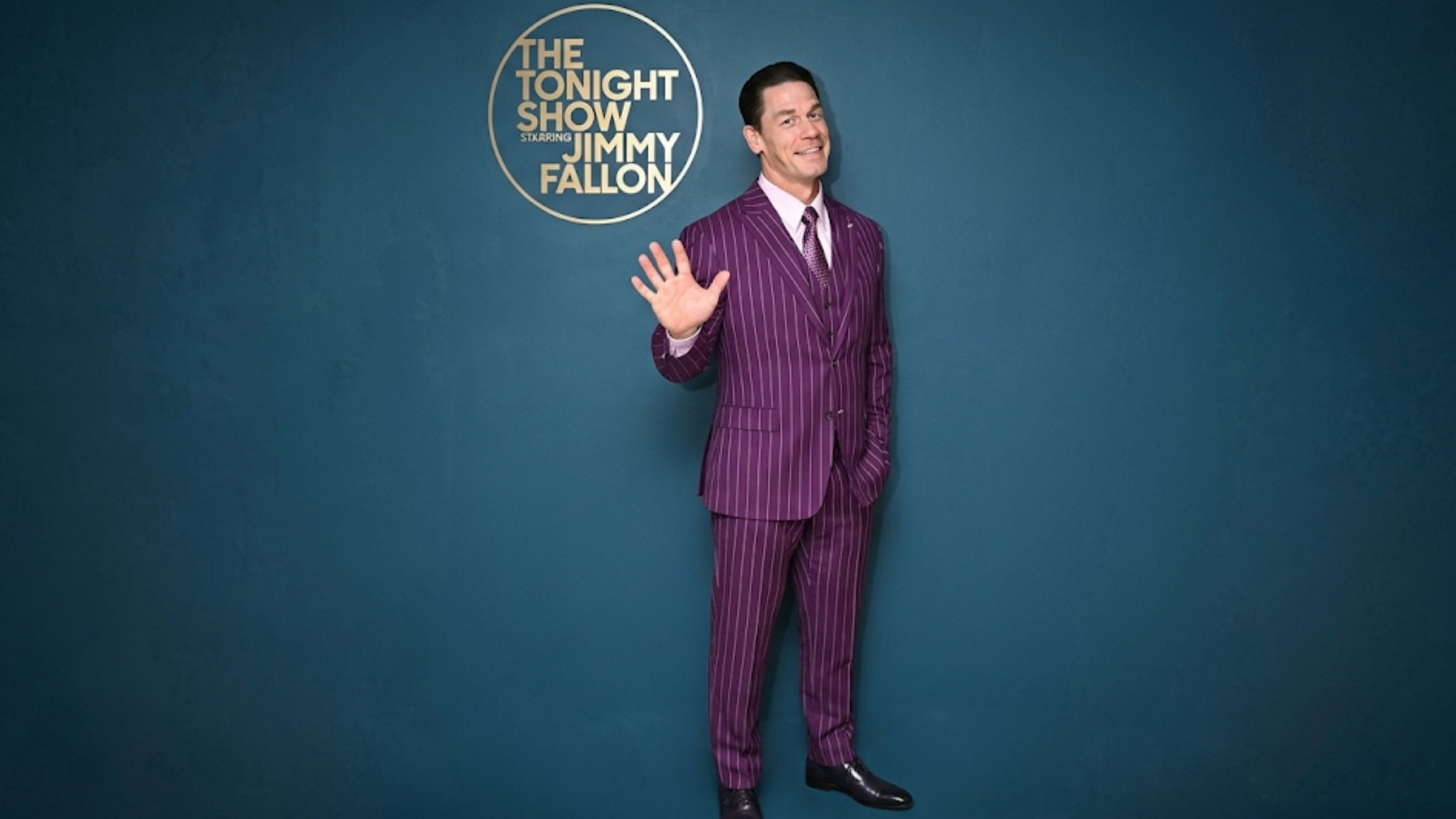 John Cena purple pinstripe blazer with notch lapels, white stripes, formal celebrity talk show outfit, The Tonight Show appearance