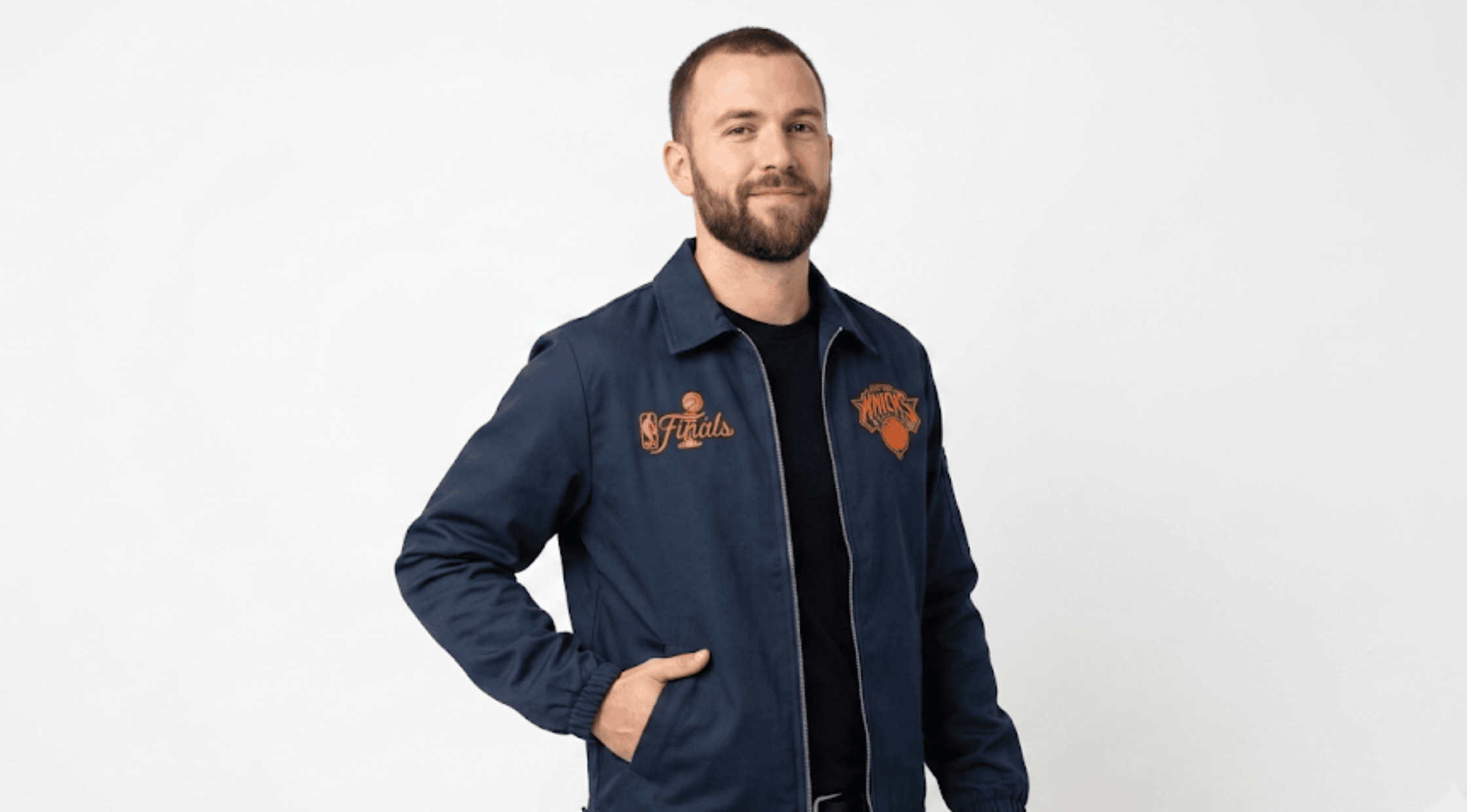 NY Knicks 2026 Champions navy blue workwear jacket with orange detailing, embroidered circular Knicks logo, and NBA Finals graphics